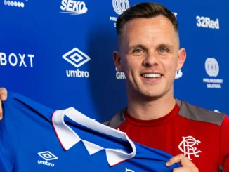 Lawrence Shankland holding a Rangers FC shirt after he signed on with the club.